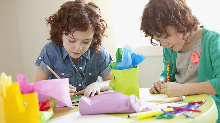 Young girls making cards.