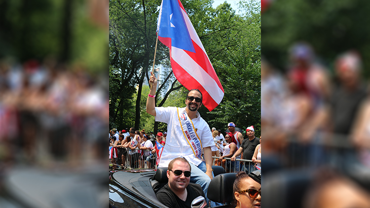 Lin-Manuel Miranda waves to the crowd in the Puerto Rican Day Parade.