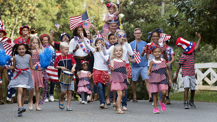 Children marching in 4th of July parade in park