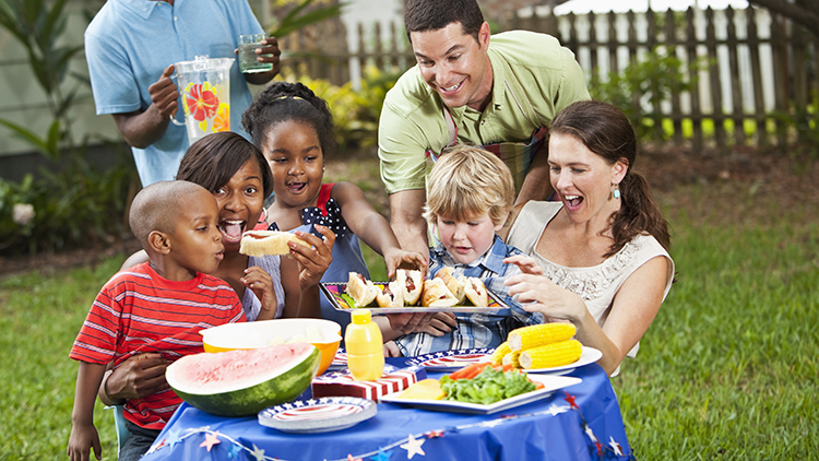 Two families having a cookout. (Man holding pitcher is not in focus).