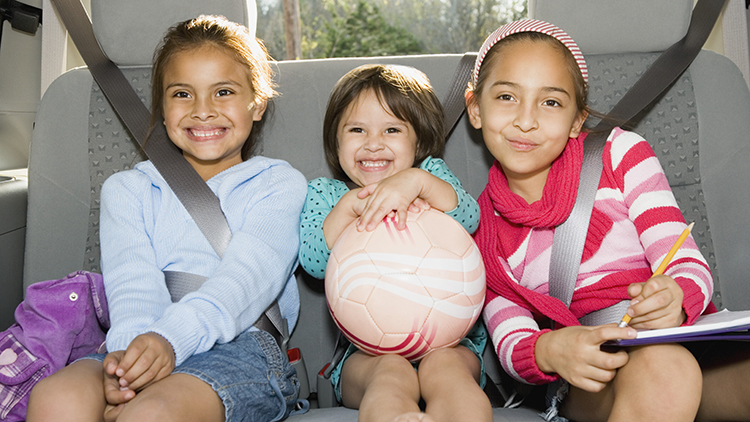 Sisters riding in back of minivan