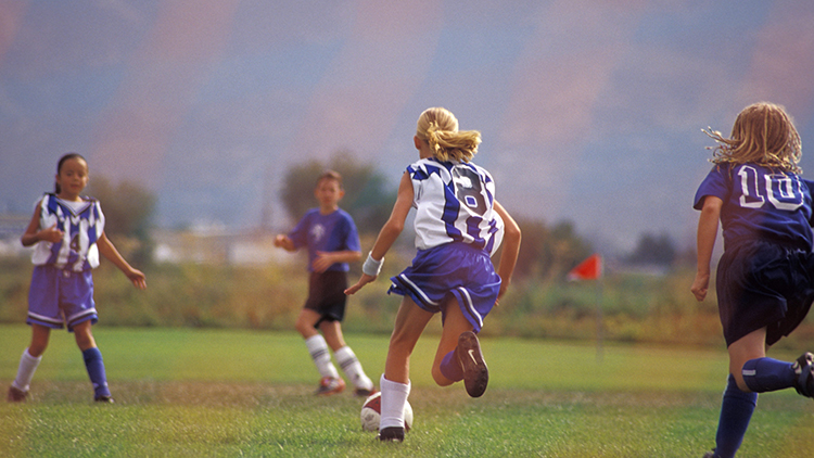 girl playing soccer