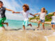 children wearing white shirts on beach